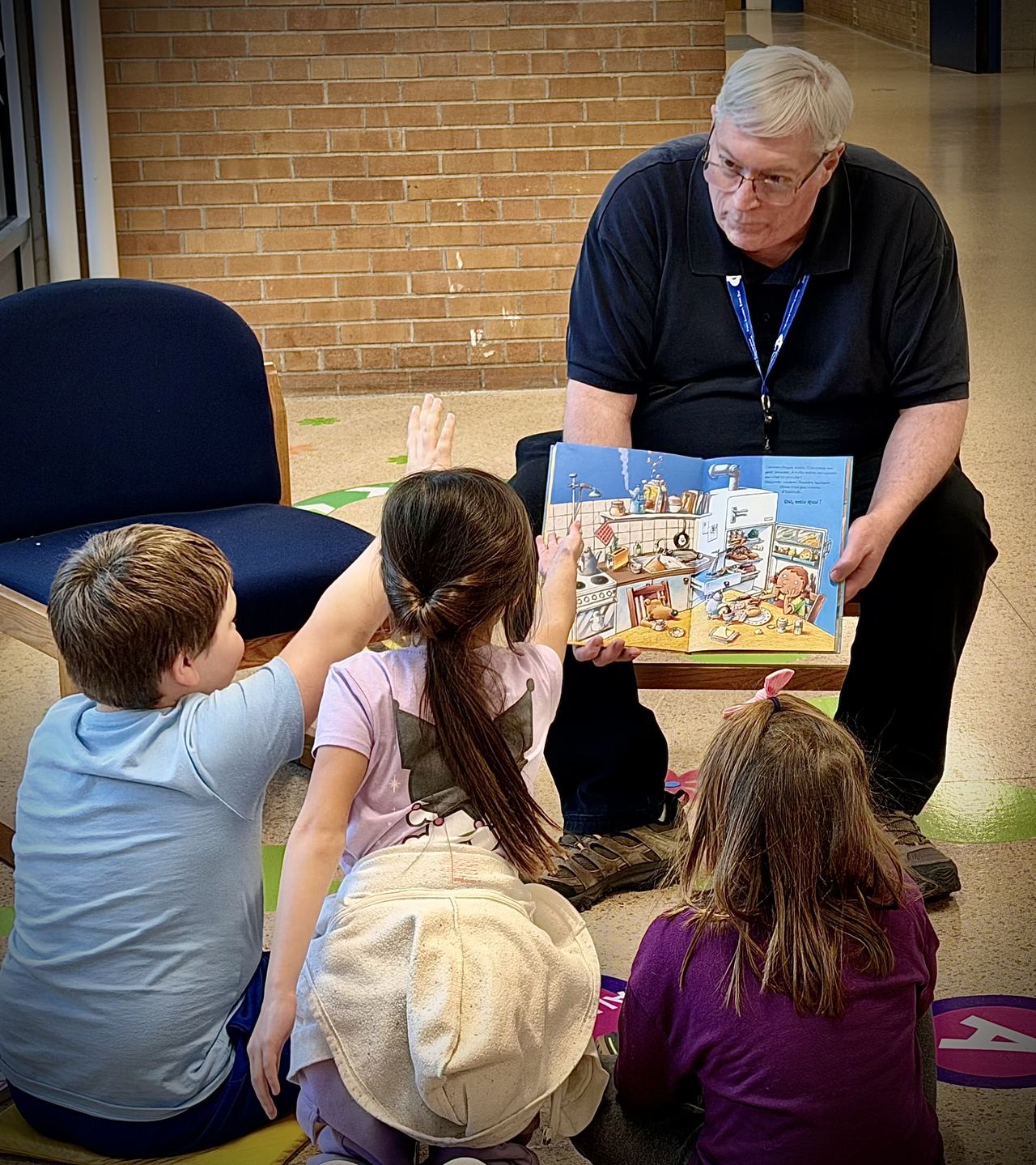 Jim reading to primary students at the CPS book exchange